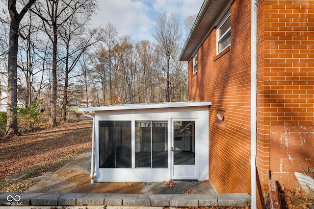 view of home's exterior with a sunroom