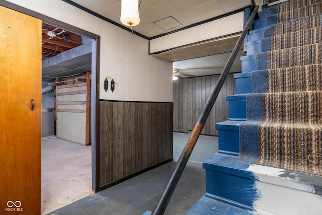 basement featuring wood walls