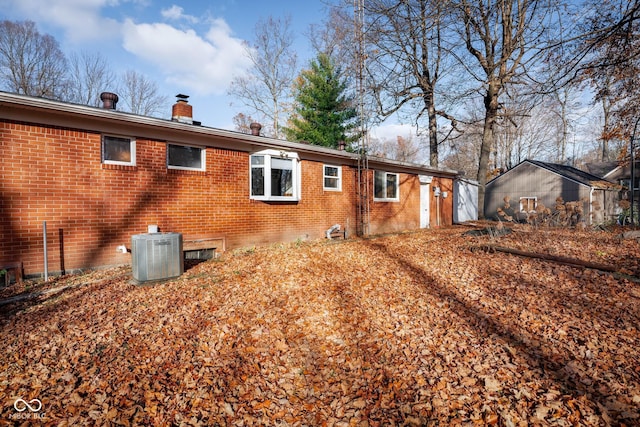 rear view of property with central air condition unit