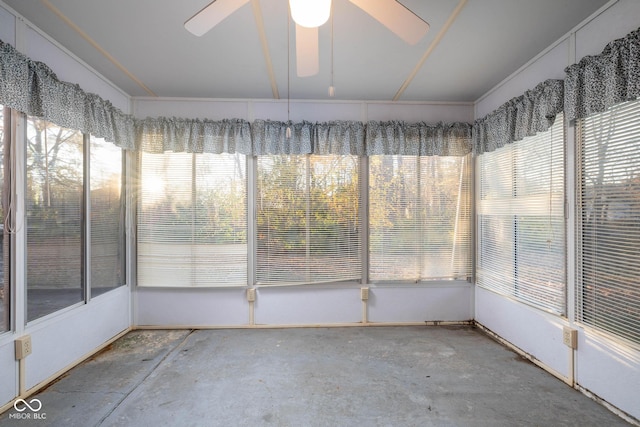 unfurnished sunroom featuring ceiling fan