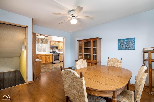 dining area featuring dark hardwood / wood-style floors and ceiling fan