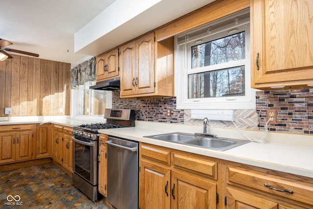 kitchen featuring decorative backsplash, sink, ceiling fan, and appliances with stainless steel finishes