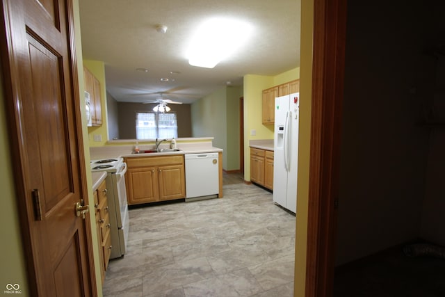 kitchen featuring kitchen peninsula, white appliances, ceiling fan, and sink