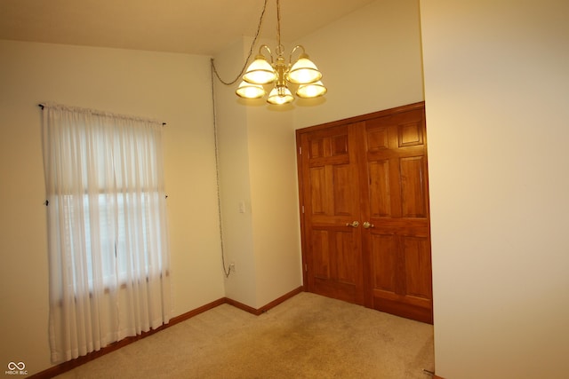 interior space with a notable chandelier and lofted ceiling