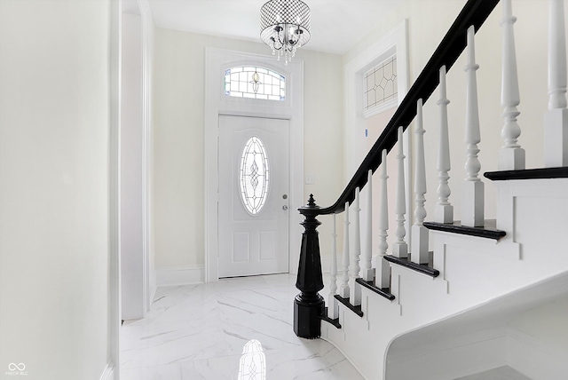 entryway featuring a notable chandelier