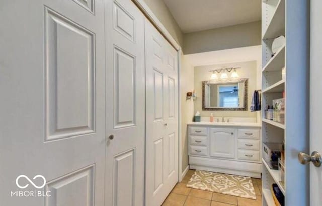 bathroom featuring tile patterned flooring and vanity