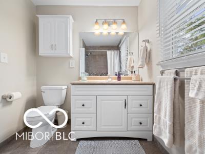 bathroom with a shower with curtain, toilet, and vanity