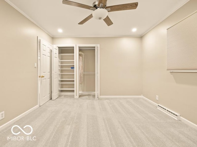 unfurnished bedroom featuring ceiling fan, light carpet, and multiple closets