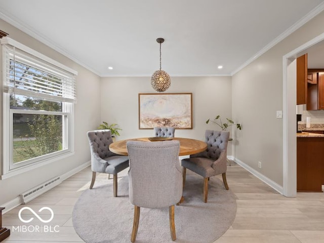 dining area featuring light hardwood / wood-style floors, plenty of natural light, and crown molding