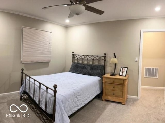 carpeted bedroom featuring ceiling fan and crown molding