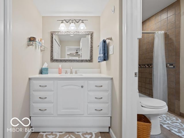 bathroom with a shower with curtain, vanity, and toilet