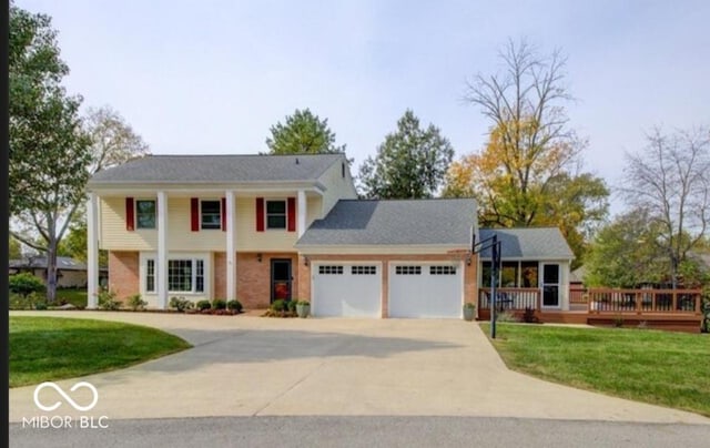 view of front of house with a garage and a front yard