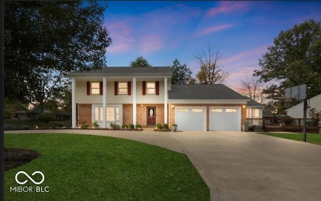 view of front of home featuring a yard and a garage