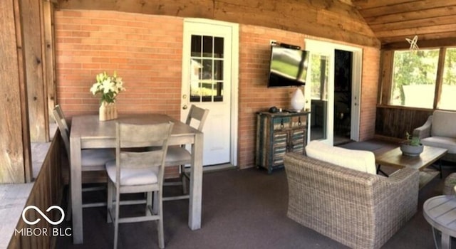 sunroom / solarium featuring wooden ceiling and lofted ceiling