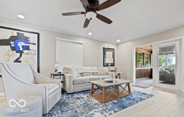 living room featuring hardwood / wood-style floors and ceiling fan