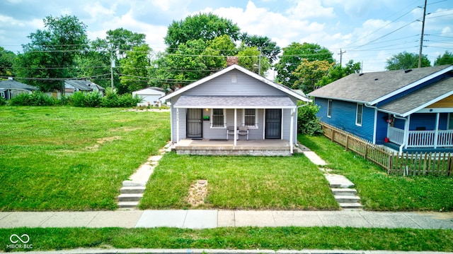 bungalow featuring a front lawn and covered porch