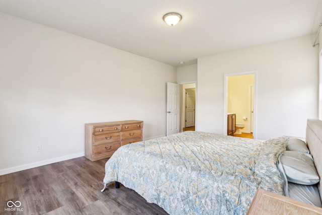 bedroom featuring hardwood / wood-style floors and ensuite bath