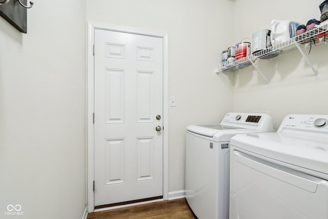 clothes washing area featuring dark hardwood / wood-style flooring and washing machine and clothes dryer