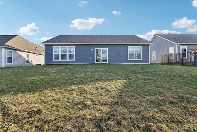 rear view of property with a lawn