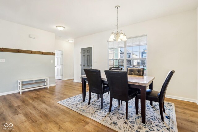 dining room featuring a chandelier and wood-type flooring