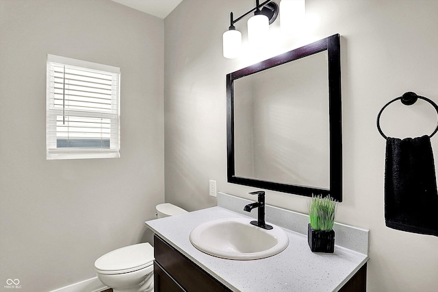 half bathroom featuring toilet and vanity