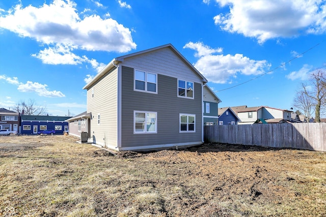 rear view of property with fence