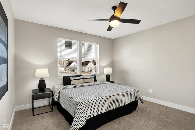 carpeted bedroom with a ceiling fan and baseboards