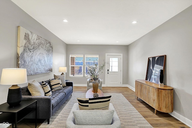 living area featuring light wood-style flooring, baseboards, and recessed lighting