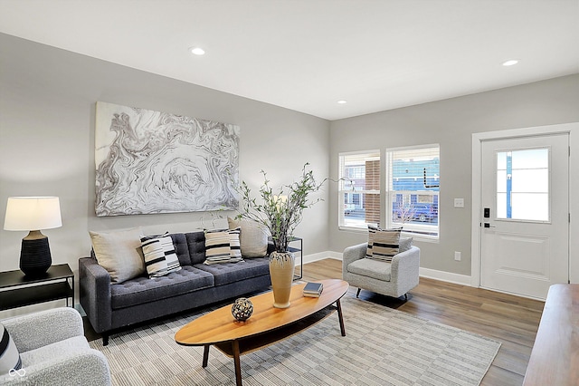 living area with recessed lighting, plenty of natural light, wood finished floors, and baseboards