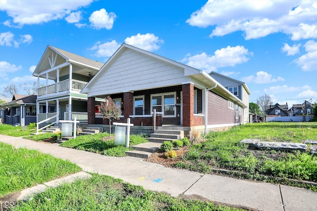 1622-1624 Prospect St, Indianapolis, IN 46203 - bungalow-style home featuring a porch, a residential view, a balcony, and brick siding