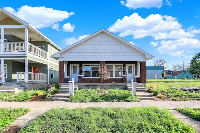 1622-1624 Prospect St, Indianapolis, IN 46203 - view of front of home with a porch, a balcony, and brick siding
