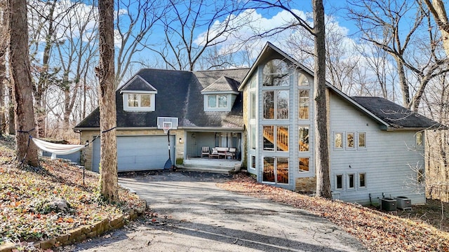 view of front of house featuring a garage and central air condition unit