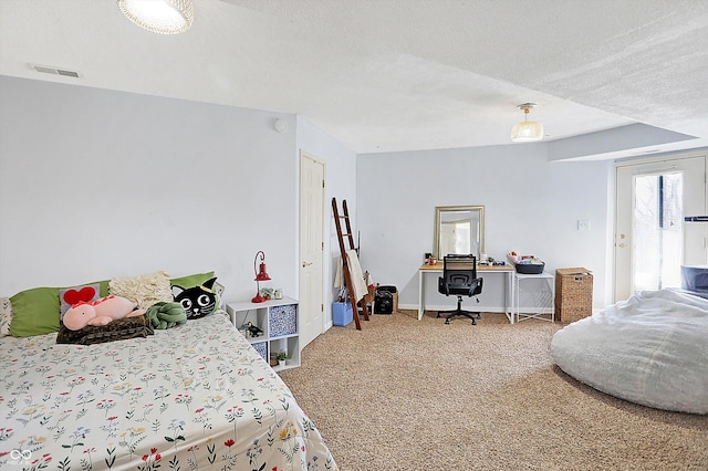 carpeted bedroom featuring a textured ceiling