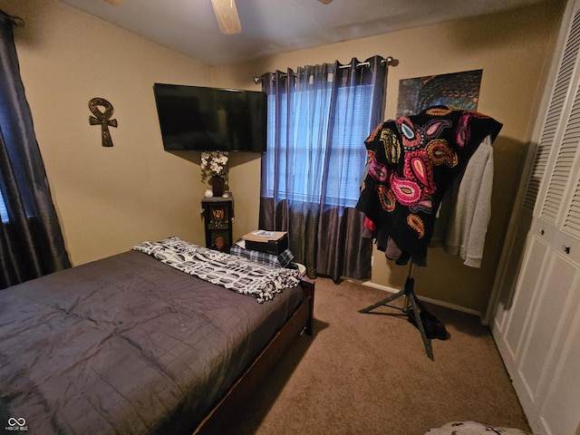 carpeted bedroom featuring a closet and ceiling fan