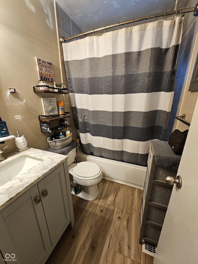 full bathroom with vanity, shower / bath combination with curtain, and toilet