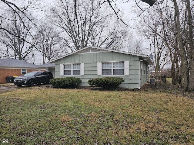 view of property exterior featuring a yard and central AC