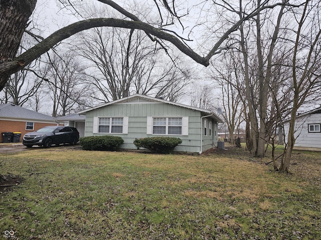 view of side of property with a yard