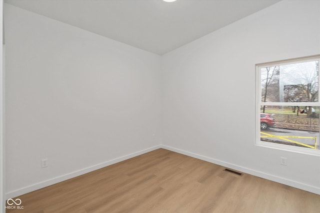 unfurnished room with light wood-type flooring