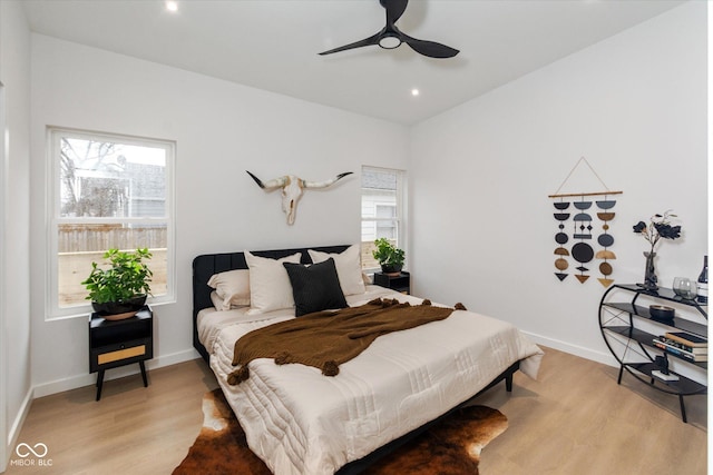 bedroom with ceiling fan and light hardwood / wood-style flooring