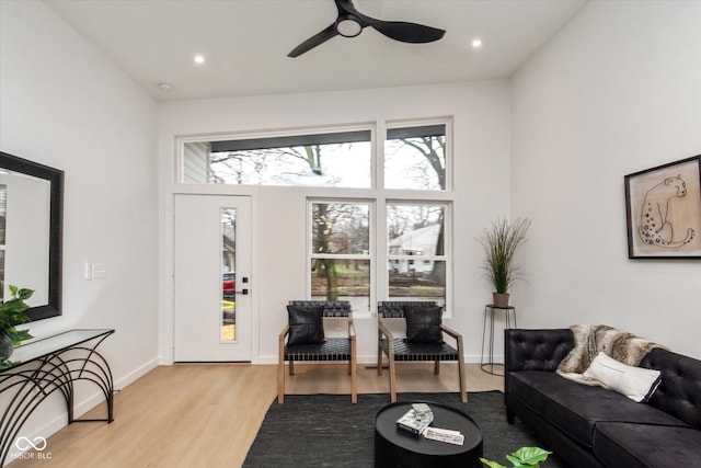 living room with ceiling fan and light hardwood / wood-style floors