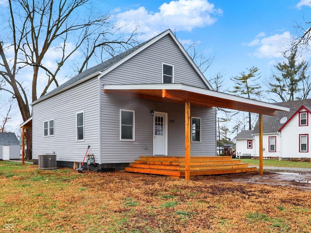 view of front of house featuring cooling unit and covered porch