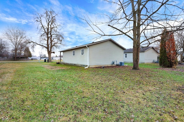 view of side of property with a lawn