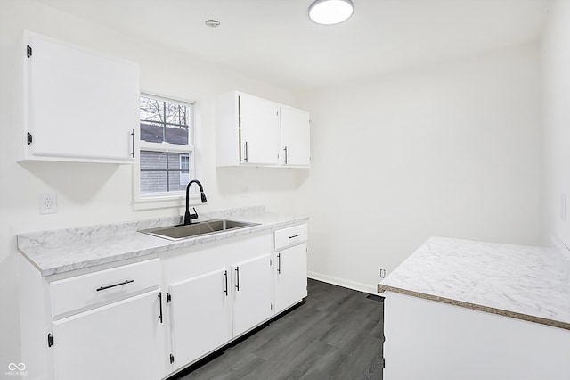 kitchen with sink, white cabinets, and dark hardwood / wood-style floors