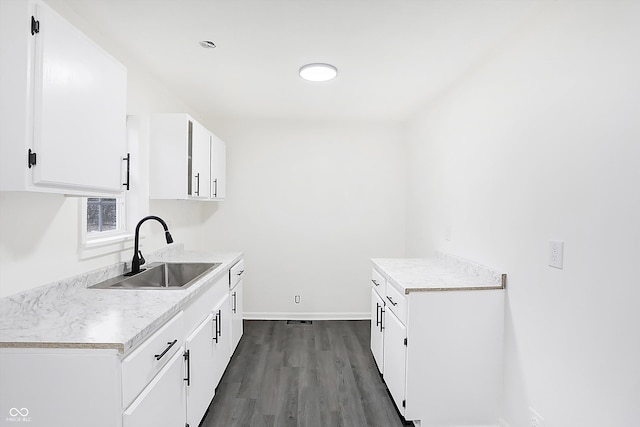 kitchen featuring white cabinets, sink, and dark wood-type flooring