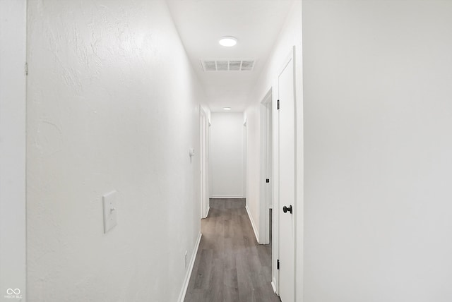 corridor with hardwood / wood-style flooring