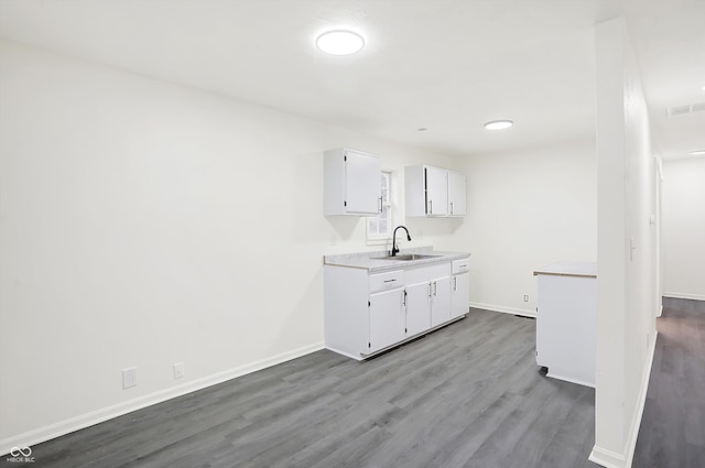 kitchen featuring sink, white cabinets, and light wood-type flooring