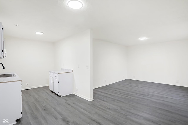 laundry area featuring sink and hardwood / wood-style flooring