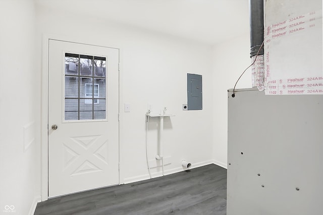 laundry room with electric dryer hookup, electric panel, and dark wood-type flooring