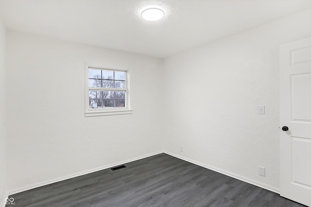 empty room featuring dark wood-type flooring