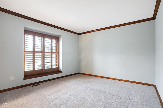 spare room with carpet flooring and ornamental molding